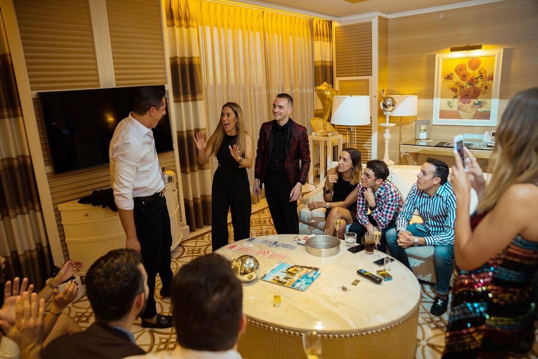 Guests gathered around a table during a private suite card routine