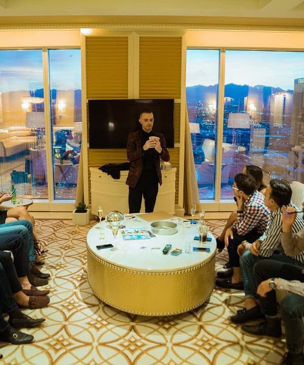 Chris Dare performs for guests in a penthouse suite overlooking the Las Vegas Strip at dusk